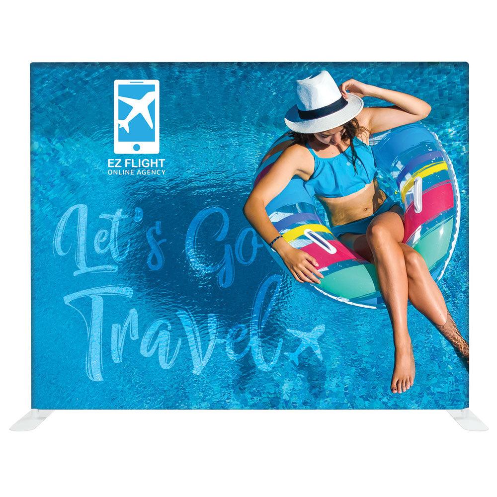 Trade show display backdrop featuring travel agency branding with woman floating in pool for exhibitions