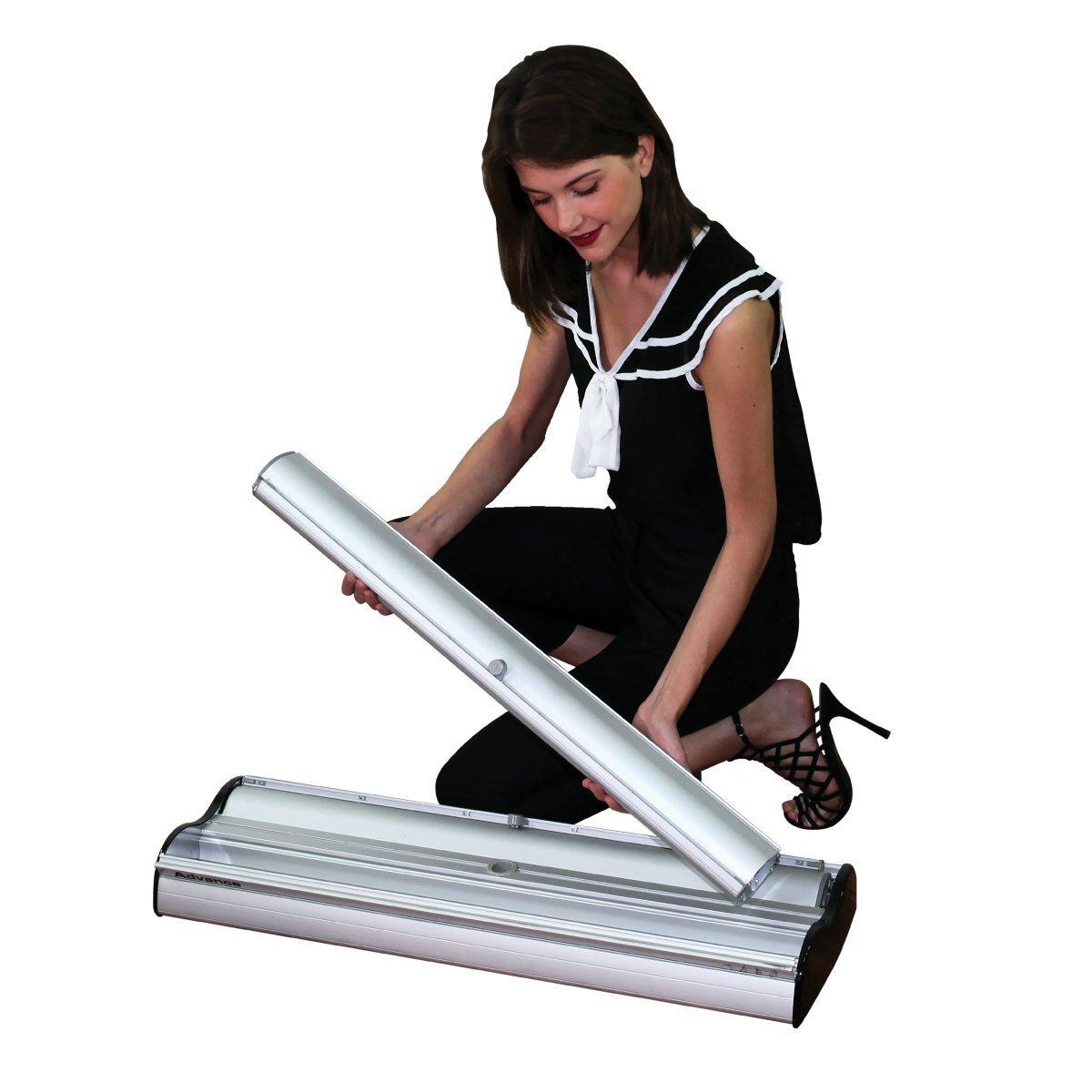 Woman assembling retractable banner stand for trade shows, exhibitions, and special events display