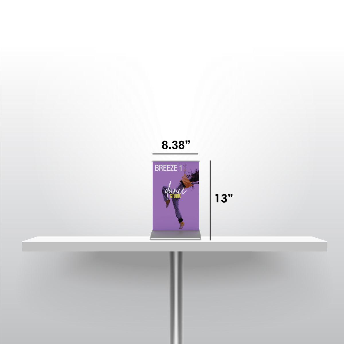 Compact tabletop banner stand for trade shows and exhibitions on a white table with size markings
