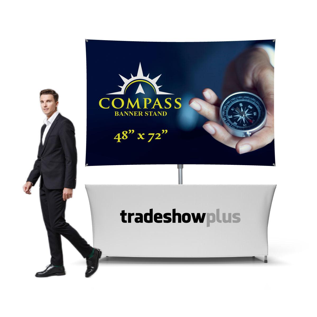 Trade show booth setup with Compass banner stand and branded table cover for exhibitions and events
