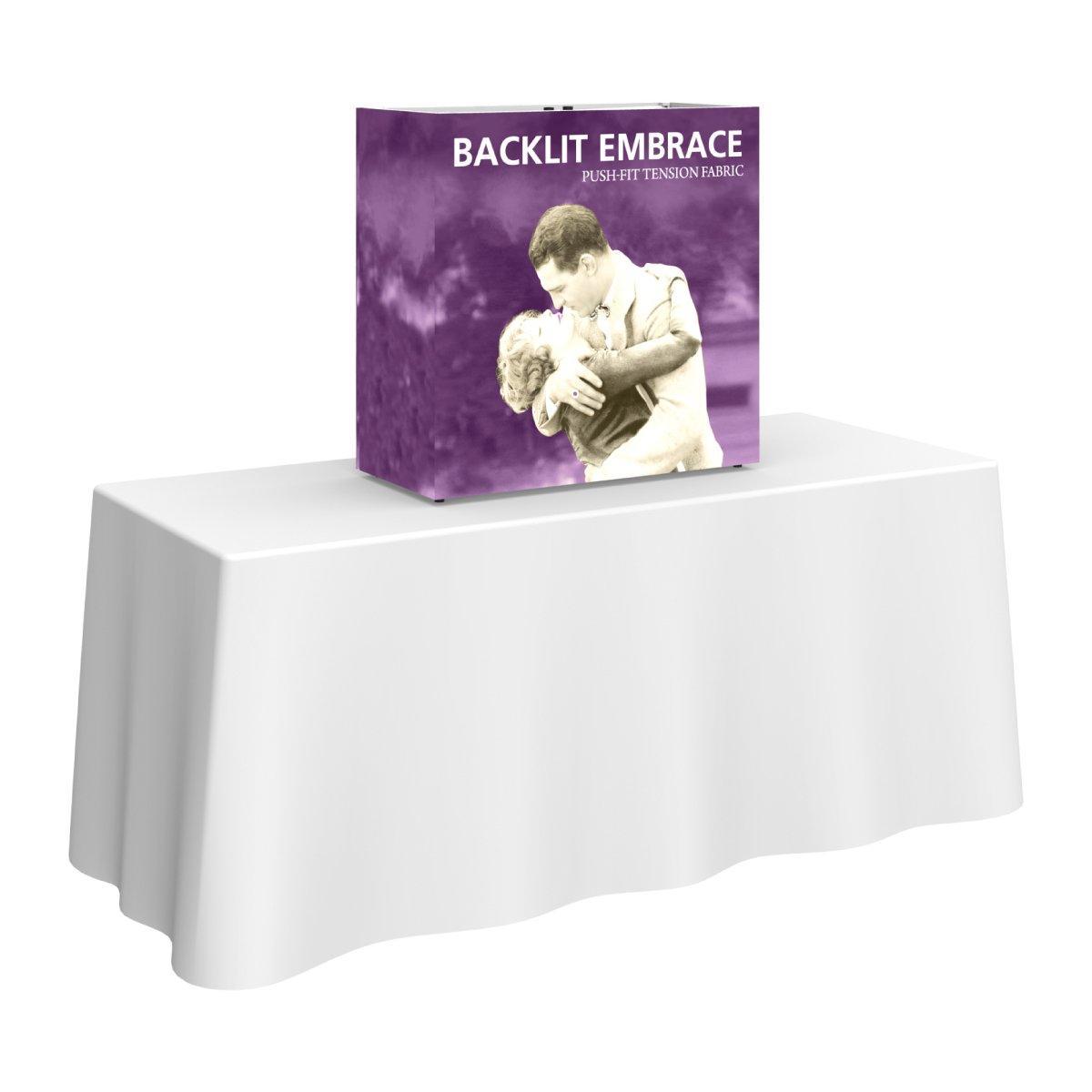 Backlit tabletop trade show display with push-fit tension fabric on white draped table
