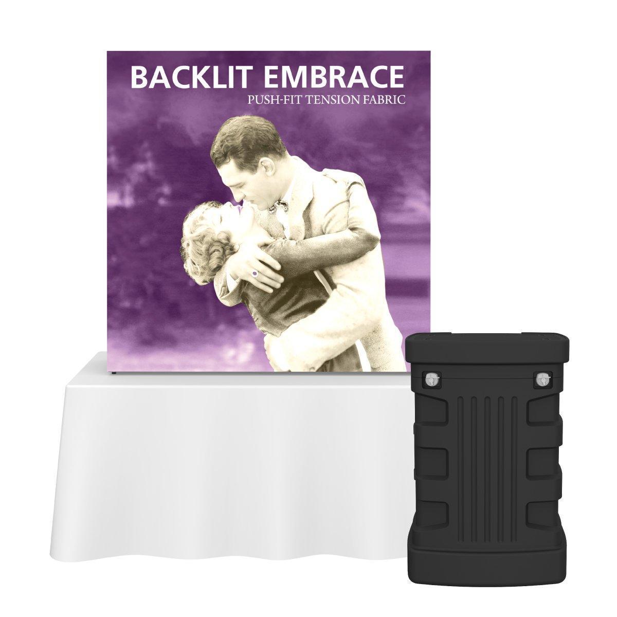 Backlit Embrace push-fit tension fabric display on tabletop with carrying case for trade shows