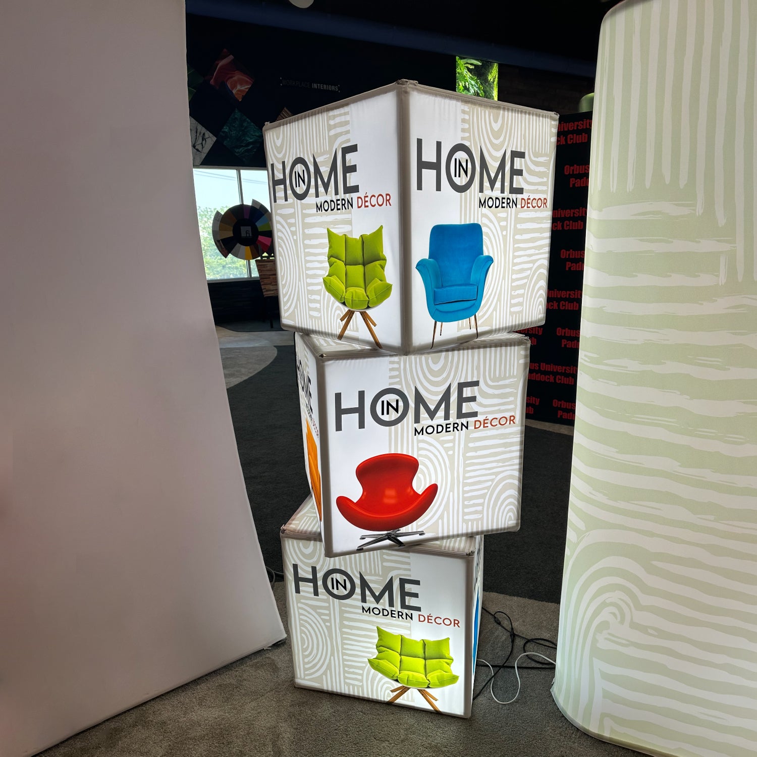 Stacked illuminated display cubes featuring modern décor chair designs for trade shows and exhibitions