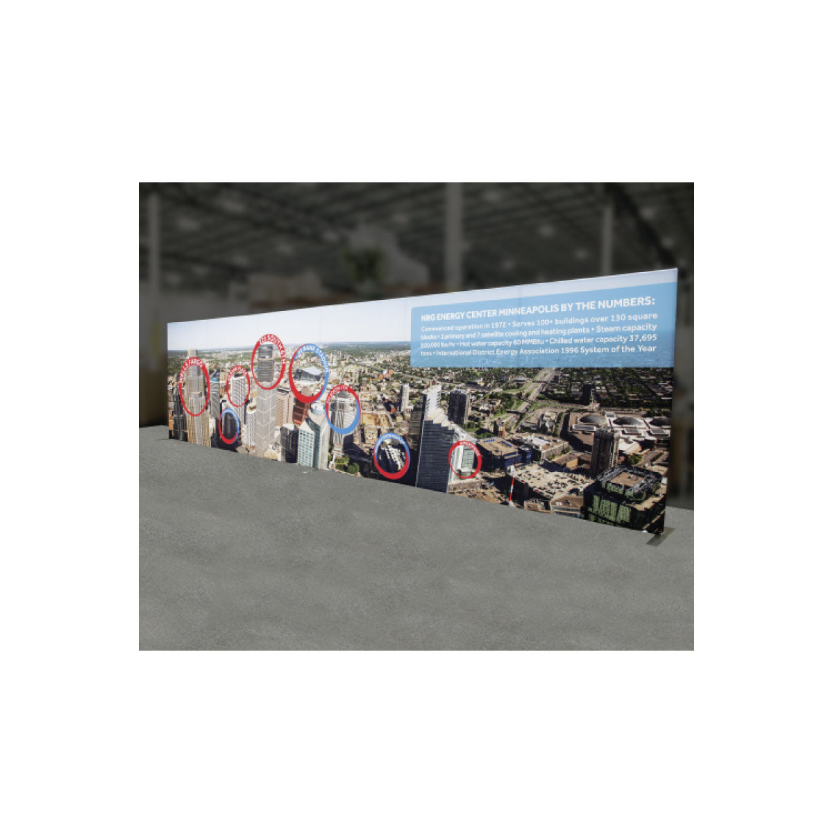 Large freestanding trade show display with cityscape graphic and informational text for exhibitions and events