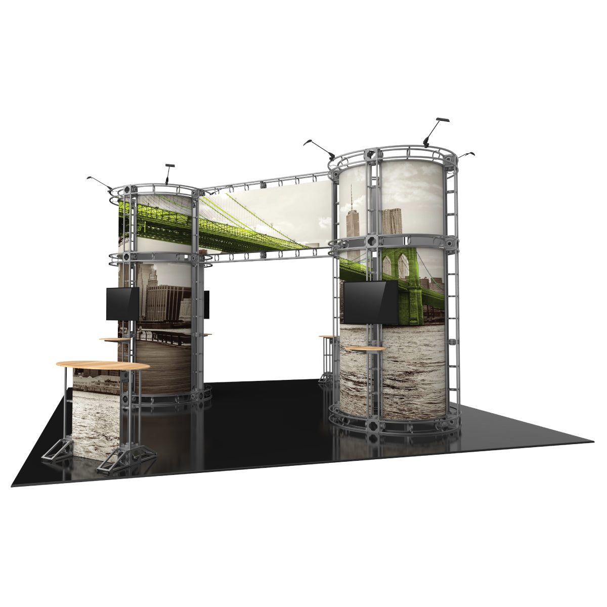 Modular trade show display with large cylindrical towers, graphic panels, mounted TVs, and countertops