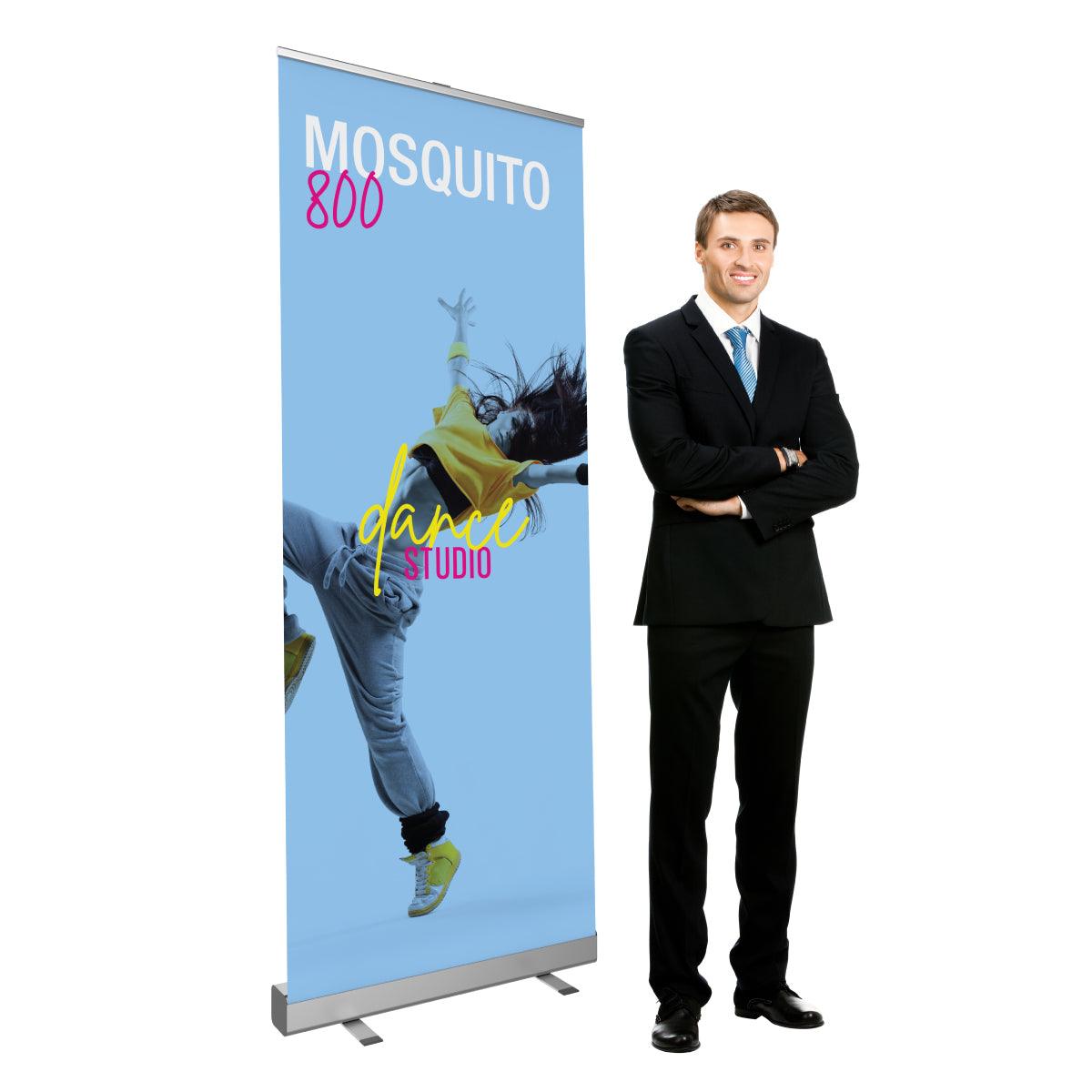 Retractable banner stand with dance studio print displayed next to businessman, ideal for trade shows and exhibitions