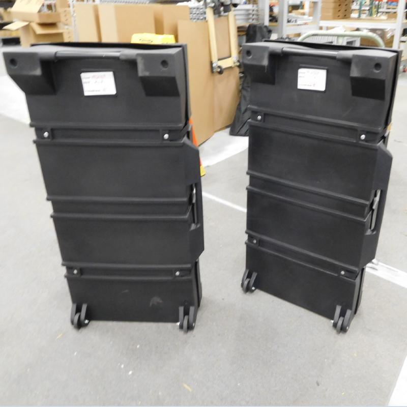 Two large hard shipping cases with wheels designed for trade shows and special event equipment transport