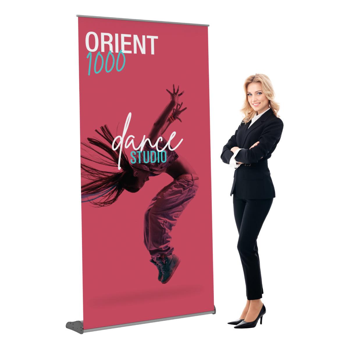 Professional woman standing next to large roll-up banner for dance studio exhibition display