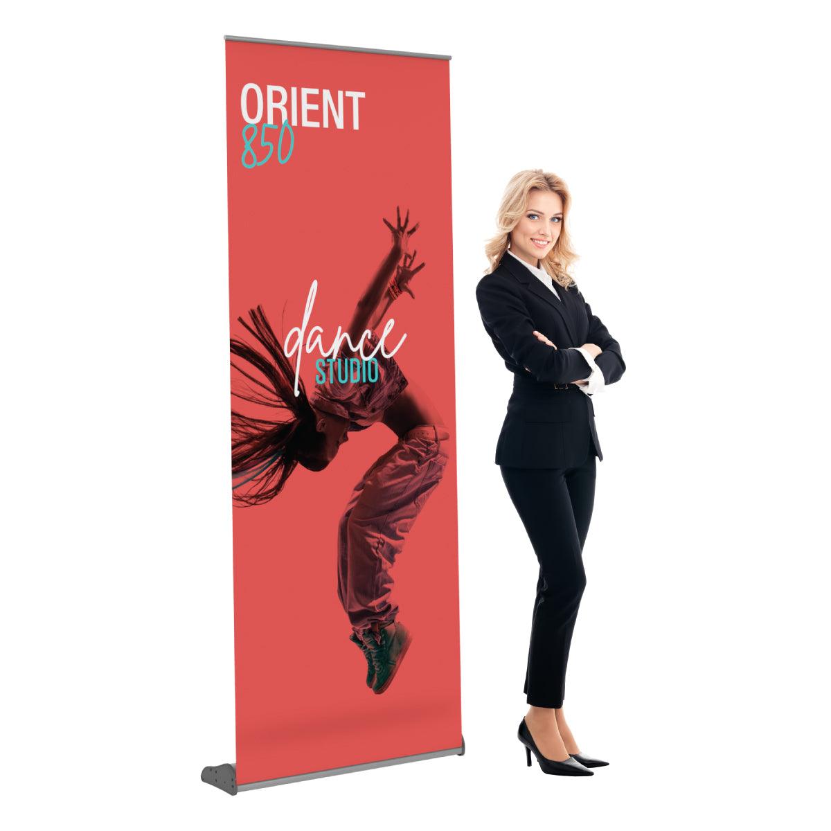 Retractable banner stand displaying dynamic dance studio advertisement at trade shows and special events with standing businesswoman