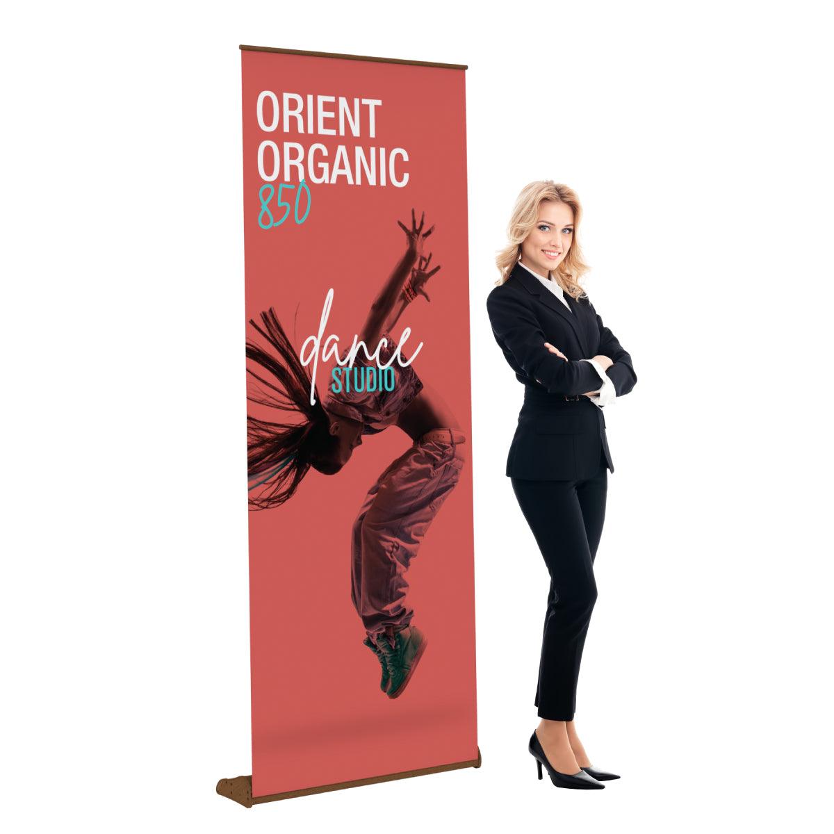 Retractable banner stand with dance studio advertisement displayed at trade shows and exhibitions, beside a businesswoman