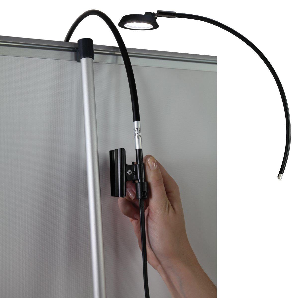 Adjustable clip-on LED light attached to trade show banner stand for exhibitions and events