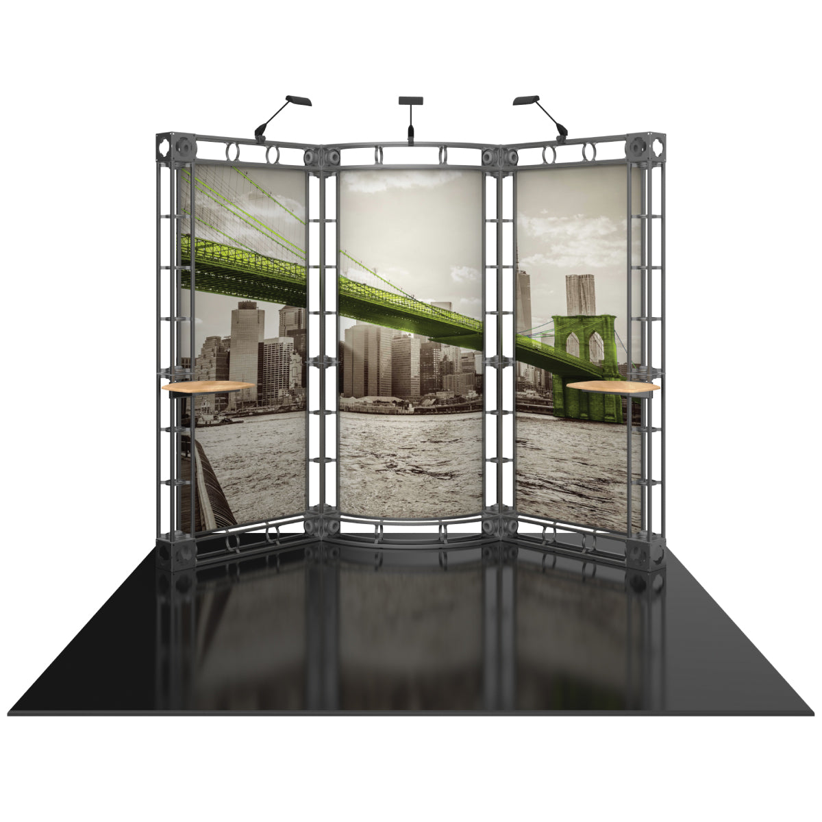 Three-panel modular truss display with scenic city bridge graphic, spotlight fixtures, and tabletop shelves for trade shows