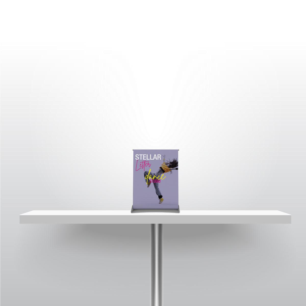 Compact tabletop banner stand displaying dance studio graphics for trade shows and events