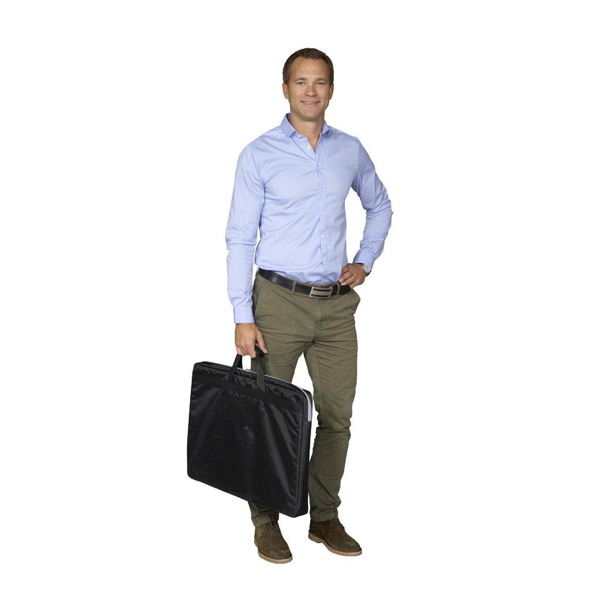 Man holding a portable trade show display carry bag for exhibitions and special events