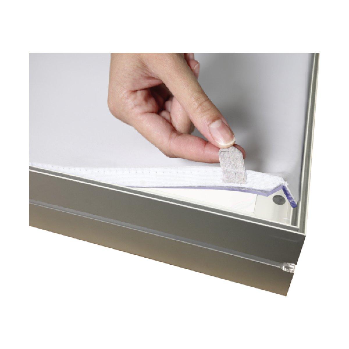 Hand attaching fabric graphic to trade show display frame using Velcro strip