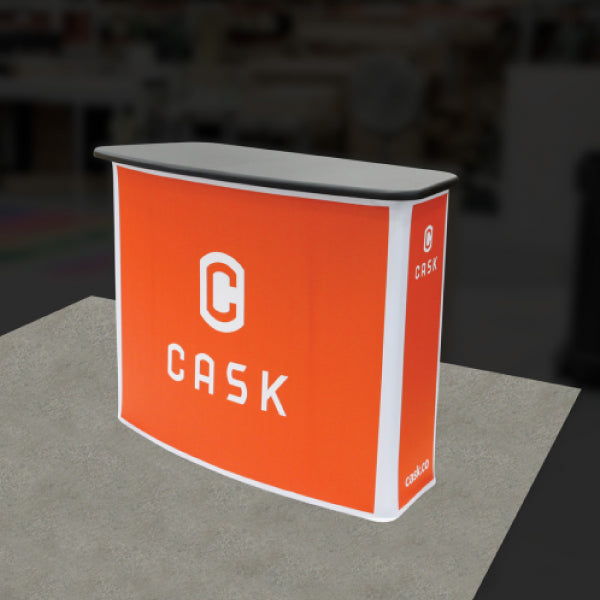 Portable trade show display counter with branded fabric wrap and sleek tabletop for exhibitions