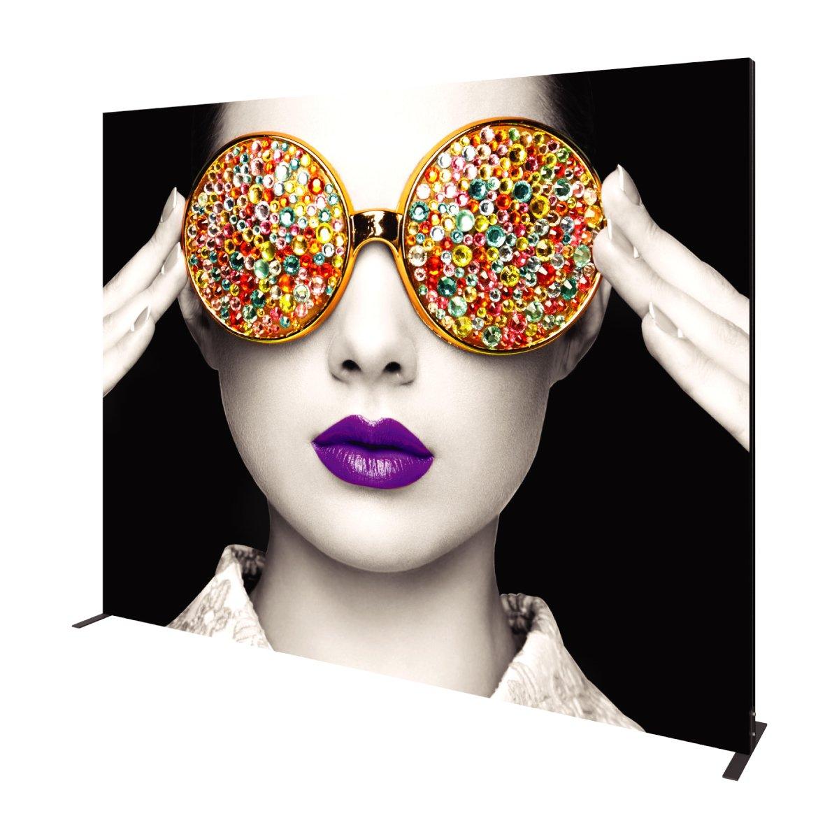 Large trade show backdrop featuring artistic portrait of woman with jeweled sunglasses and bold lips