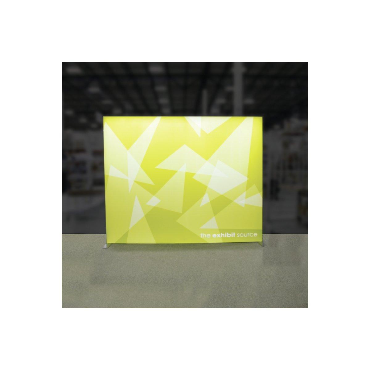 large illuminated trade show display backdrop with geometric patterns in an exhibition space