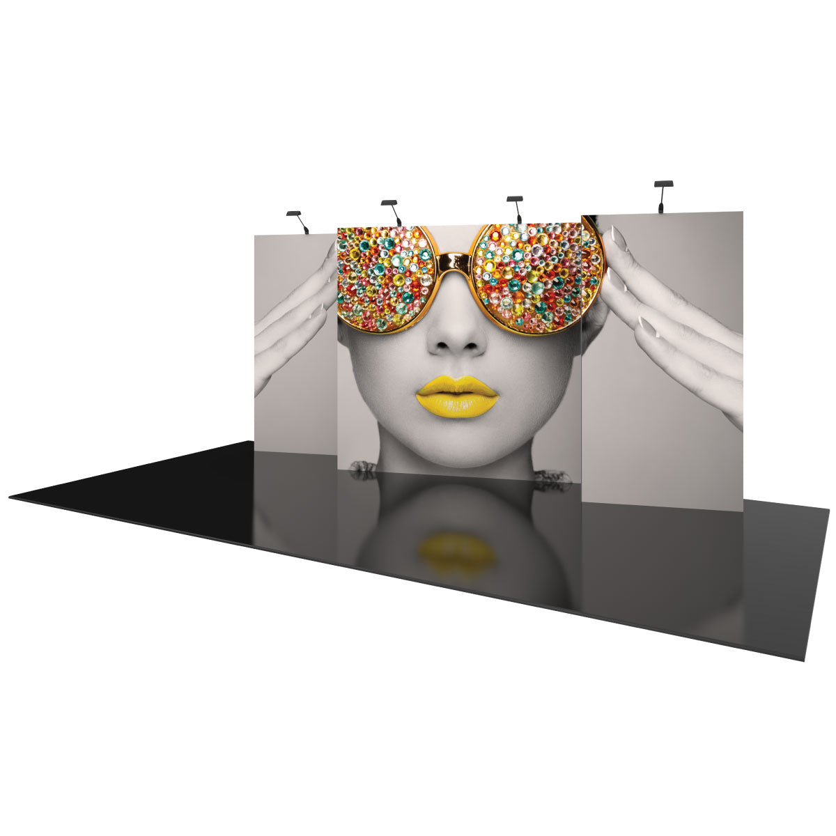 Trade show backdrop featuring large graphic panels with artistic portrait and jewel-adorned sunglasses