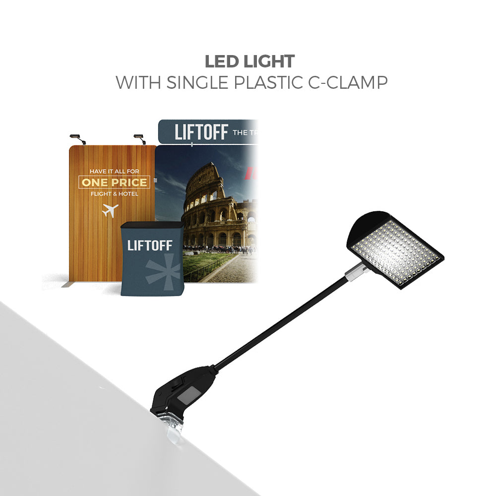 LED light with plastic C-clamp illuminating trade show display booth graphics and promotional counter