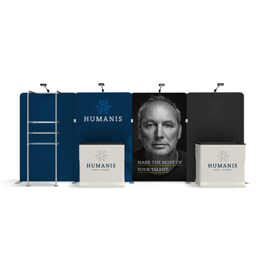 Trade show display featuring branded backdrop panels, light fixtures, and promotional counters for exhibitions