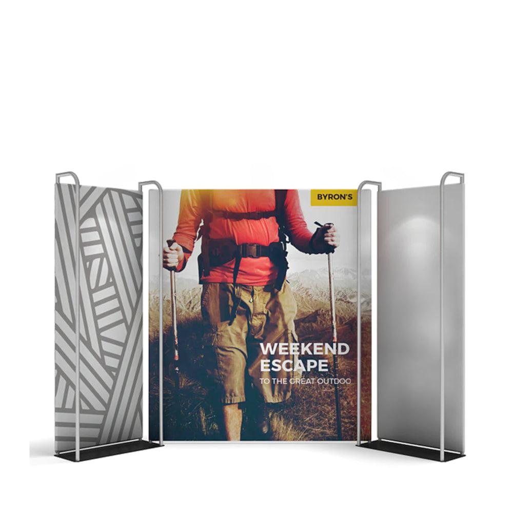 Trade show display with three panel fabric backdrop featuring adventure-themed graphics for exhibitions and events