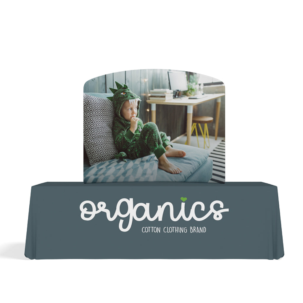 Curved tabletop trade show display with child in dinosaur costume for organic cotton clothing brand