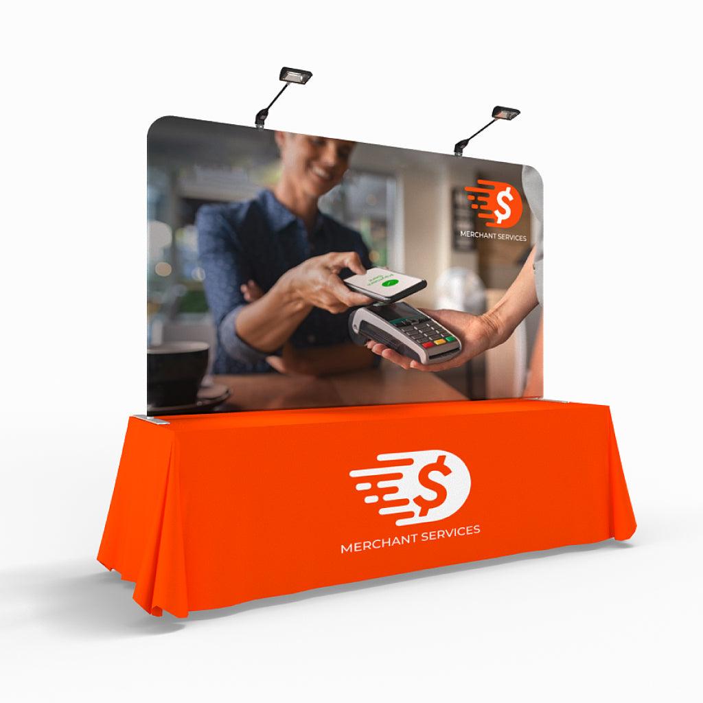 Trade show tabletop display with custom branded fabric table cover and graphic backdrop for exhibitions