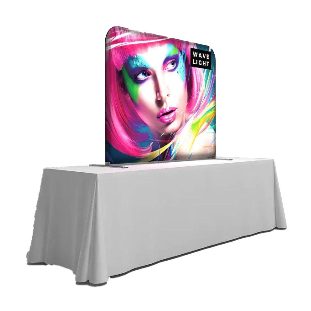 Tabletop light box display featuring vibrant graphic of a stylized face for trade shows and events