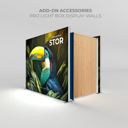 Trade show light box display wall with vibrant toucan graphic and wooden storage partition for exhibitions