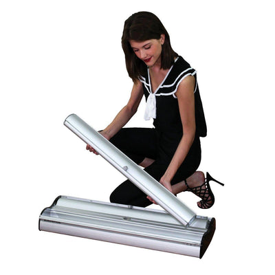 Woman assembling retractable banner stand for trade shows, exhibitions, and special events display