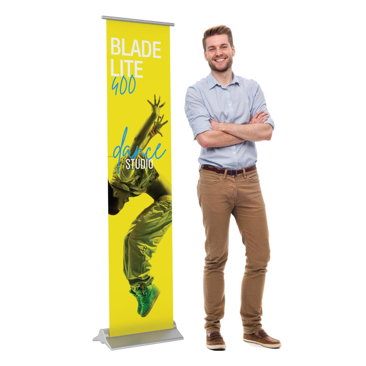 Blade Lite 400 banner stand with dance studio graphic displayed next to smiling man at trade show