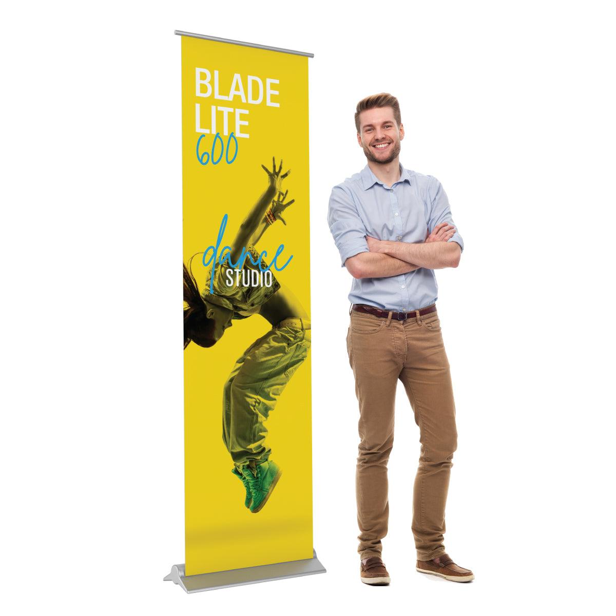 Blade Lite 600 banner stand displaying dance studio promotion for trade shows and exhibitions with man standing next to it