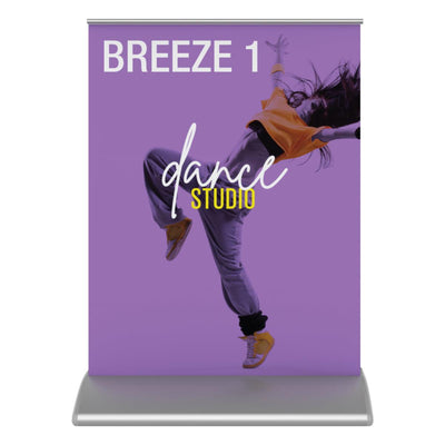 Trade show tabletop banner stand featuring dynamic dance studio advertisement with jumping dancer