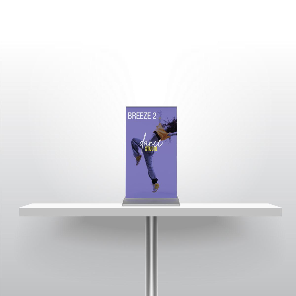 Compact tabletop banner stand on table showcasing dance studio promotion for trade shows and events