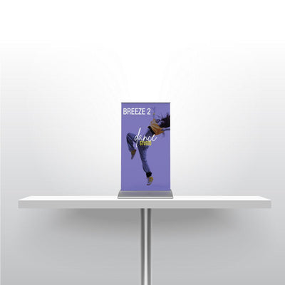 Compact tabletop banner stand on table showcasing dance studio promotion for trade shows and events