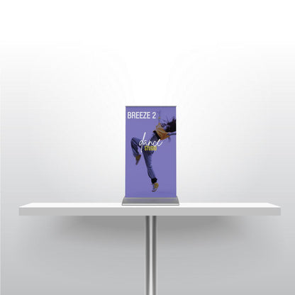 Compact tabletop banner stand on table showcasing dance studio promotion for trade shows and events
