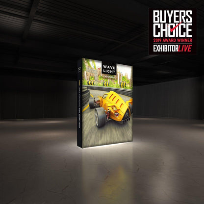 Backlit freestanding trade show display featuring racing car graphics in a dark exhibition space