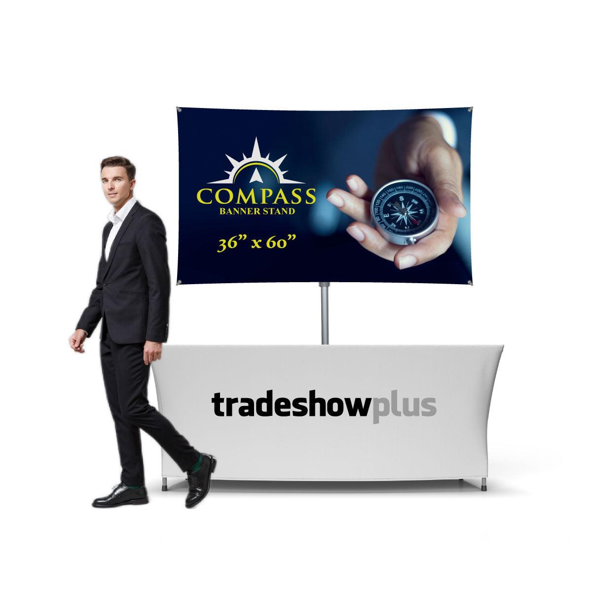 Trade show booth with compass banner stand and branded table cover for exhibitions and events