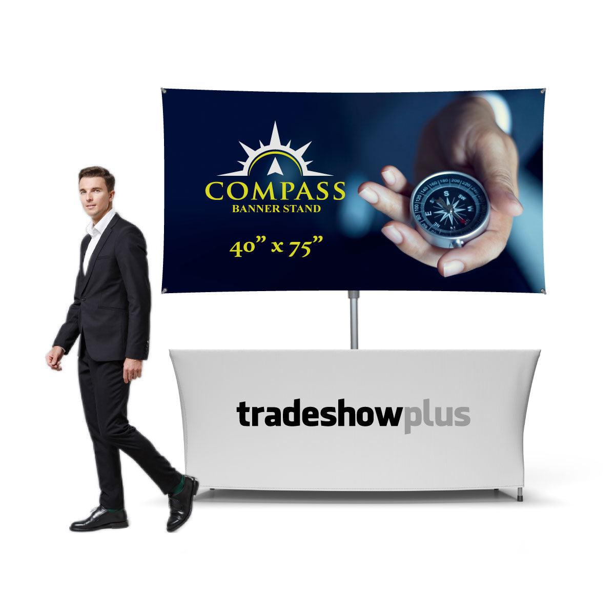 Compass banner stand 40x75 inches displayed above trade show table with man in suit for exhibitions and events
