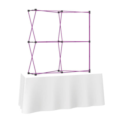 Curved fabric tabletop display frame on covered table for trade shows and exhibitions