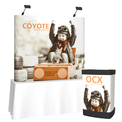Trade show display setup with Coyote popup backdrop and OCX case to counter featuring joyful child image