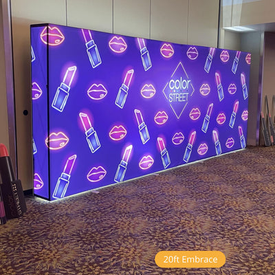 Large illuminated trade show display backdrop with lipstick and lip icon graphics for Color Street brand