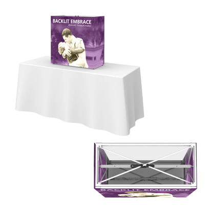 Backlit Embrace tension fabric tabletop display on a table, ideal for trade shows and exhibitions