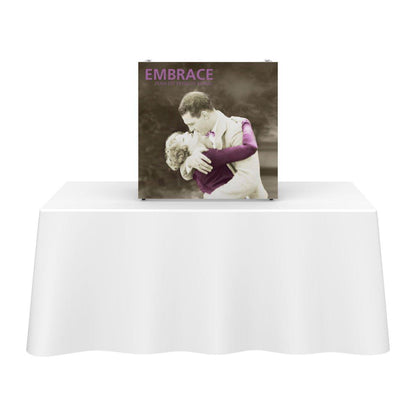Tabletop display on covered trade show table featuring vintage couple embracing for exhibition marketing