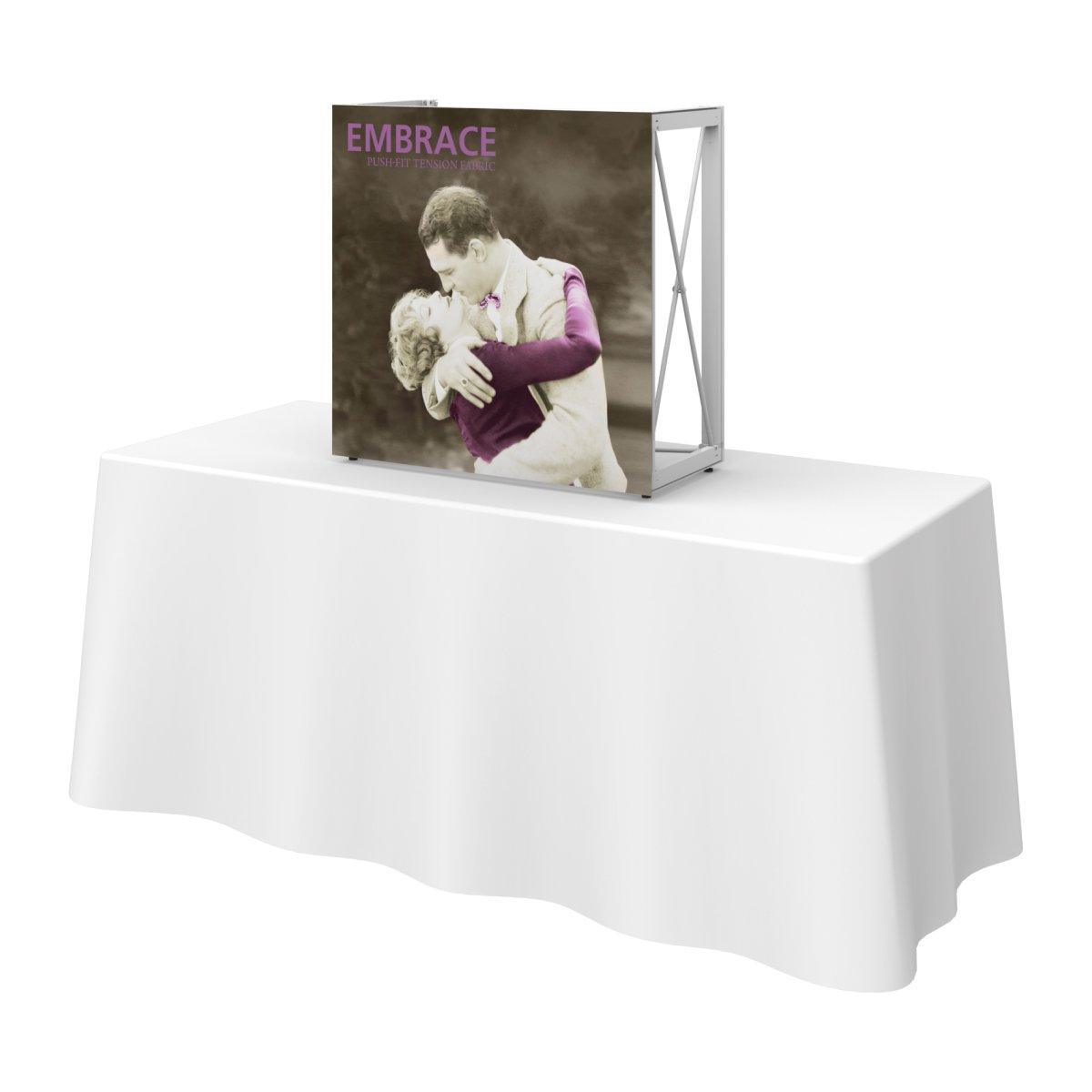 Compact tabletop display with push-fit fabric graphic showing an embracing couple, ideal for trade shows and events
