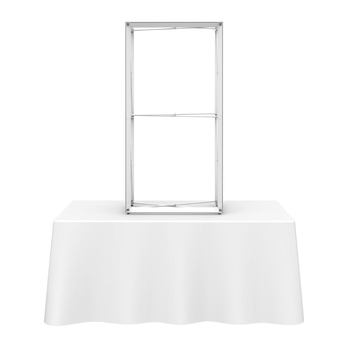 Extra tall tabletop display frame on covered table for trade show and event branding