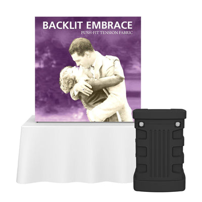 Backlit Embrace push-fit tension fabric display on tabletop with carrying case for trade shows