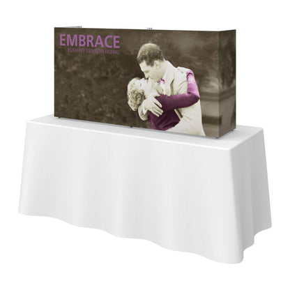 Compact tabletop trade show display with printed fabric featuring vintage romantic embrace image