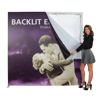 Woman assembling large backlit display with vintage couple image for trade shows and exhibitions